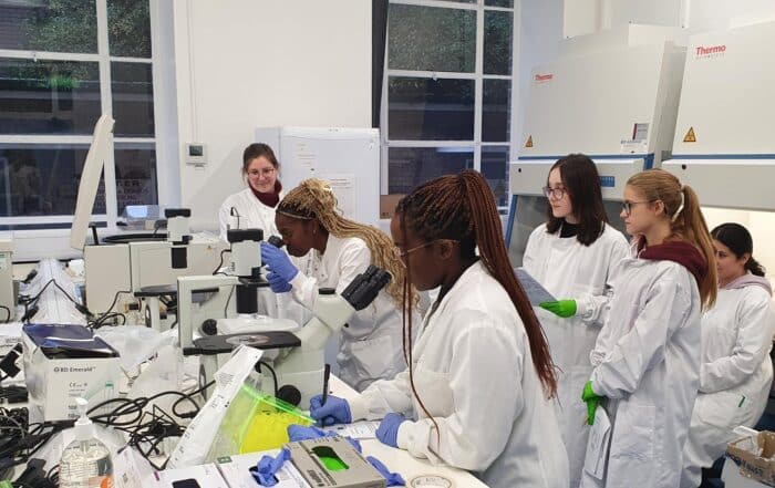 A group of apprentices in a laboratory learning how to use equipment