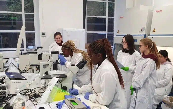 A group of apprentices in a laboratory learning how to use equipment