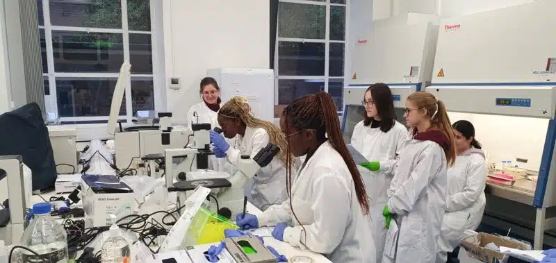 A group of apprentices in a laboratory learning how to use equipment