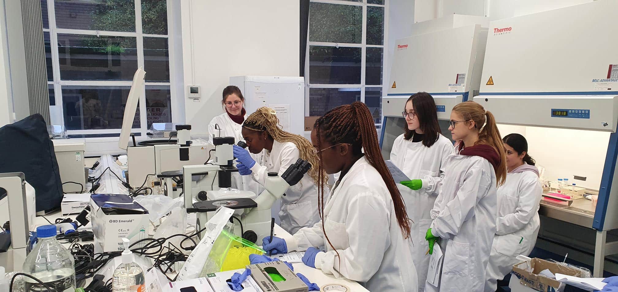 A group of apprentices in a laboratory learning how to use equipment