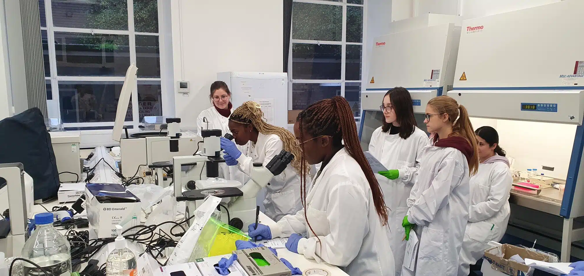 A group of apprentices in a laboratory learning how to use equipment